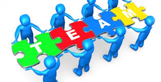 Clipart image of people holding puzzle pieces that spell out team.